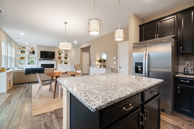 open concept living room and kitchen with dark wood floors and white granite counters